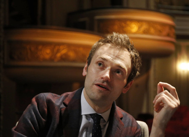 In this April 5, 2016 photo, Chris Thile speaks during an interview at the Fitzgerald Theater in St. Paul, Minn. Thile will replace Garrison Keillor as host of "A Prairie Home Companion," the popular public radio variety show, after Keillor retires this summer. Thile starts hosting a 13-episode run of the show in October. (AP Photo/Ann Heisenfelt)