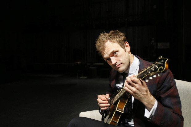 In this April 5, 2016 photo, Chris Thile plays his mandolin on stage at the Fitzgerald Theater in St. Paul, Minn. Thile will replace Garrison Keillor as host of "A Prairie Home Companion," the popular radio variety show, after Keillor retires this summer. Thile starts hosting a 13-episode run of the show in October. (AP Photo/Ann Heisenfelt)