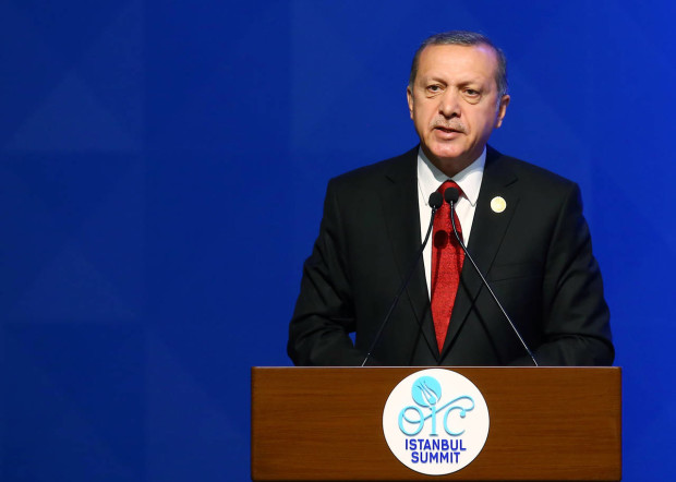 Turkey's President Recep Tayyip Erdogan addresses the leaders and representatives of the Islamic countries during the opening of the 13th Organization of Islamic Cooperation, OIC, Summit in Istanbul, Thursday, April 14, 2016. Turkish President Recep Tayyip Erdogan says Muslim nations have agreed to establish a joint body to fight terrorism and urged the countries’ leaders to examine the root causes of the migration crisis. Addressing the summit of the OIC in Istanbul on Thursday, he stressed terrorism is the largest problem confronting the Muslim world. (Anadolu Agency/Pool Photo via AP)