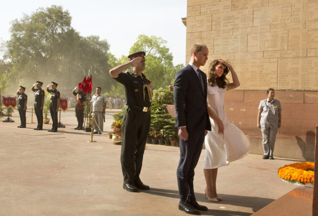 Britain's Prince William, along with his wife Kate, the Duchess of Cambridge, right, pay their tributes at the India Gate war memorial, in the memory of the soldiers from Indian regiments who served in World War I, in New Delhi, India, Monday, April 11, 2016. (Manish Swarup/Pool Photo via AP)