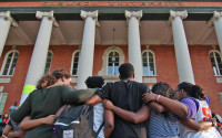 Clemson University students gather on the steps of Sikes Hall to protest exclusion, racial insensitivity, and administrative inaction at the university in Clemson, S.C., Thursday, April 15, 2016. Five students were given a citation for trespassing in Sikes Hall, following a sit in to also protest a campus incident Monday, April 11 in which students hung bananas from an African-American history banner. (Ken Ruinard/Anderson Independent-Mail via AP)