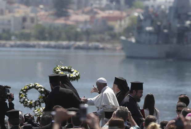 Pope Francis, center, flanked by Ecumenical Patriarch Bartholomew I, spiritual leader of the world’s Orthodox Christians, left, and Archbishop of Athens and All Greece Ieronymos II, head of the Church of Greece, toss floral wreaths into the sea, on the Greek island of Lesbos, Saturday April 16, 2016. The heads of the Catholic and Orthodox churches have conducted a prayer ceremony for refugees at the port of Mytilene, the capital of the Greek island of Lesbos where hundreds of thousands of have passed through on perilous journeys from the Turkish coast toward Europe. (AP Photo/Petros Giannakouris)