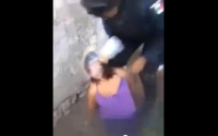 This screengrab of a video posted on several youtube sites on April 14, 2016 shows a plastic bag held tight over a woman's head by an unidentified federal police officer in an unknown location in Mexico. Two Mexican soldiers face military charges after this video surfaced of them helping a federal police officer torture a female suspect. It's unclear if the police officer faces charges. Mexico's Defense Department says the events occurred Feb. 4, 2015 in a small mountain town in southern Guerrero state. (via AP)