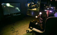 In this Wednesday April 6, 2016, photo, Associated Press reporter Mae Anderson experiences playing the virtual reality horror game set "Until Dawn: Rush of Blood," using Sony’s PlayStation VR headset, in New York. VR is clearly a medium in its infancy and creators are still devising new storytelling techniques that can exploit the technology’s power. But it’s impossible to deny the technology’s underlying potential. (AP Photo/Bebeto Matthews)