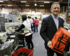 Founder and CEO Mark Dwight holds a backpack while posing at his Rickshaw Bagworks factory on Monday, April 4, 2016, in San Francisco. The San Francisco Board of Supervisors is voting on whether to require six weeks of fully paid leave for new parents - a move that would be a first for any jurisdiction. The proposal to be voted on Tuesday would require San Francisco employers with at least 20 employees to make up the rest. (AP Photo/Eric Risberg)