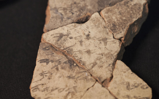 Letters inscribed on pottery, known as ostracons, which were unearthed in an excavation of a fort in Arad, Israel, and dated to about 600 B.C. shortly before Nebuchadnezzar’s destruction of Jerusalem, are seen in Israel Museum in Jerusalem Tuesday, April 12, 2016.  A Tel Aviv University team determined that this famous hoard of ancient Hebrew inscriptions was written by at least six different authors. Although the inscriptions are not from the Bible, their discovery suggests there was widespread literacy in ancient Judah at the time that would support the composition of biblical works. (AP Photo/Dan Balilty)