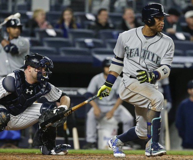 Seattle Mariners' Robinson Cano follows through on an RBI single during the fourth inning of a baseball game as New York Yankees catcher Brian McCann watches, Friday, April 15, 2016, in New York. (AP Photo/Frank Franklin II)