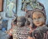 In this April 2, 2016 photo, dusty sculptures made of cast-off baby dolls sit in an open-air museum and art workshop off a trash-strewn street cutting through some of the poorest neighborhoods in Port-au-Prince, Haiti. They were created by Haitian artists called Atis Rezistans who have become celebrated in the international art world by creating sculptures out of scrapped car parts, old wood, discarded toys and even human skulls found scattered outside crumbling mausoleums. (AP Photo/David McFadden)