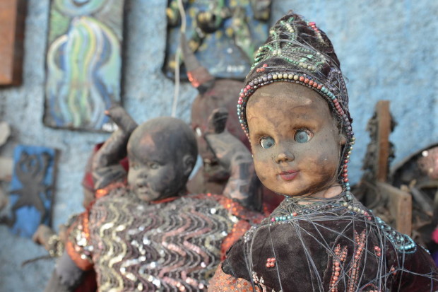 In this April 2, 2016 photo, dusty sculptures made of cast-off baby dolls sit in an open-air museum and art workshop off a trash-strewn street cutting through some of the poorest neighborhoods in Port-au-Prince, Haiti. They were created by Haitian artists called Atis Rezistans who have become celebrated in the international art world by creating sculptures out of scrapped car parts, old wood, discarded toys and even human skulls found scattered outside crumbling mausoleums. (AP Photo/David McFadden)