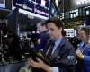 A pair of traders work on the floor of the New York Stock Exchange, Monday, April 11, 2016. U.S. stocks opened higher on Wall Street following gains overseas as investors held out hope for more economic stimulus from China. (AP Photo/Richard Drew)