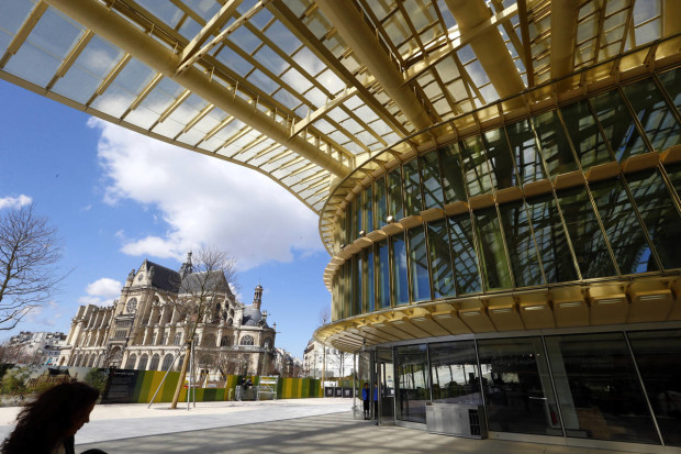 A view of the Canopy, covering the new Les Halles shopping mall, near the Eglise Saint-Eustache, seen in background, during the press visit Tuesday, April 5, 2016 in Paris, France. Paris' City Hall unveiled the long-awaited 1 billion euro revamp of the city’s dilapidated main shopping and metro complex, "Forum des Halles" often the first port of call for tourists visiting the City of Light. The project has been called the "canopy" thanks to a eye-catching ondulating roof structure. (AP Photo/Francois Mori)