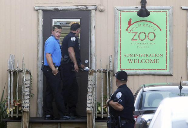 Police officers enter the administration building at the Palm Beach Zoo after zookeeper Stacey Konwiser died while being attacked by a tiger, Friday, April 15, 2016, in West Palm Beach, Fla. Stacey Konwiser, 38, was attacked and killed by a 13-year-old male tiger in an enclosure known as the night house that is not visible to the public, Palm Beach Zoo spokeswoman Naki Carter said. It's where the tigers sleep and are fed. (Damon Higgins/Palm Beach Post via AP)  MAGS OUT; TV OUT; NO SALES; MANDATORY CREDIT