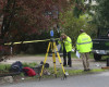 An officer takes a photo at the scene where a pickup truck slammed into children at a school bus stop in Maple Valley, Wash. (Ellen M. Banner/The Seattle Times via AP) SEATTLE OUT; USA TODAY OUT; MAGS OUT; TELEVISION OUT; NO SALES; MANDATORY CREDIT TO BOTH THE SEATTLE TIMES AND THE PHOTOGRAPHER