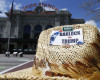 In this photo taken April 13, 2016, signs adorn the crown of the hat worn by Steve Barlock, a supporter of Republican presidential hopeful Donald Trump as he stands near Union Station in Denver.  First Barlock discovered he had to join the Republican Party to support Donald Trump in the Colorado GOP caucuses. That was the easy part. What followed was a misadventure that could plague the GOP front-runner in states to come unless Trump’s grassroots supporters, often political outsiders themselves, get more help navigating the inside battle for delegates. (AP Photo/David Zalubowski)