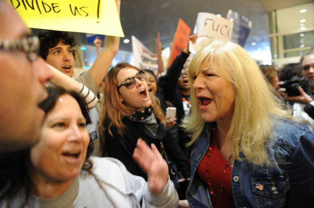 Judy Stabile of Oakmont, Pa., left, confronts anti-Trump protesters as she waits in line to enter the David L. Lawrence Convention Center for a rally for Republican presidential candidate Donald Trump in Pittsburgh, Wednesday, April 13, 2016. (Rebecca Droke/Pittsburgh Post-Gazette via AP) MAGS OUT; MONESSEN OUT; KITTANNING OUT; CONNELLSVILLE OUT; GREENSBURG OUT; TARENTUM OUT; NORTH HILLS NEWS RECORD OUT; BUTLER OUT; MANDATORY CREDIT