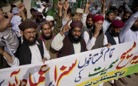 Activists of Pakistani religious group Sunni Tehreek demanding executions of court sentences given under the blasphemy law, during a protest in Rawalpindi, Pakistan, Friday, April 15, 2016. Banner reads "court sentences awarded to all blasphemers including Asia, should be implemented. " Asia Bibi, a Christian woman sentenced for death for blasphemy. (AP Photo/B.K. Bangash)