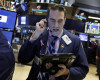 Trader Gregory Rowe works on the floor of the New York Stock Exchange, Monday, April 11, 2016. U.S. stocks opened higher on Wall Street following gains overseas as investors held out hope for more economic stimulus from China. (AP Photo/Richard Drew)