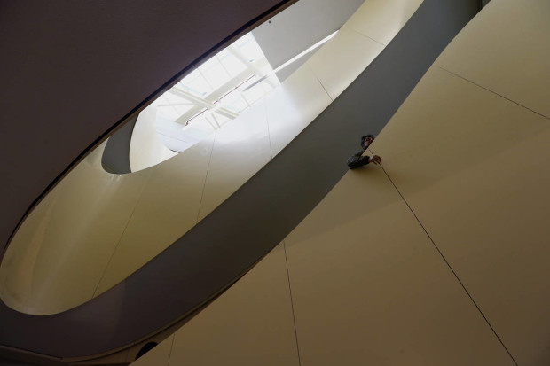 A visitor walks in the stairs inside the new Les Halles shopping mall during the press visit Tuesday, April 5, 2016 in Paris, France. Paris' City Hall unveiled the long-awaited 1 billion euro revamp of the city’s dilapidated main shopping and metro complex, "Forum des Halles" often the first port of call for tourists visiting the City of Light. The project has been called the "canopy" thanks to a eye-catching ondulating roof structure. (AP Photo/Francois Mori)