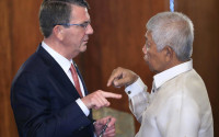 U.S. Defense Secretary Ash Carter, left, discusses with his Philippine counterpart Voltaire Gazmin during their joint press conference at the Malacanang presidential palace in Manila, Philippines on Thursday, April 14, 2016. The United States on Thursday revealed for the first time that American ships have started conducting joint patrols with the Philippines in the South China Sea, a somewhat rare move not done with many other partners in the region. (Romeo Ranoco/Pool Photo via AP)