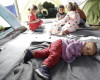 Migrant children play inside a tent at the northern Greek border point of Idomeni, Greece, Thursday, April 14, 2016. More than 12,000 people have been stuck her for more than a month amid hopes that the border would reopen.(AP Photo/Amel Emric)