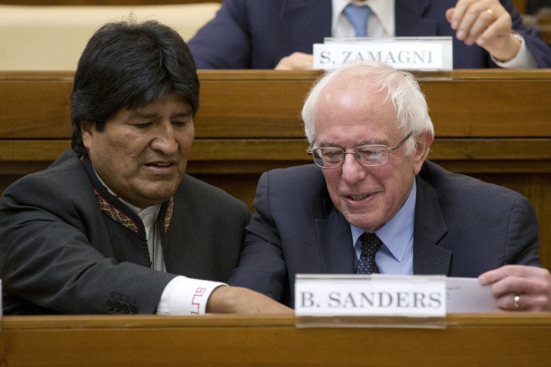 US Democratic presidential candidate, Sen. Bernie Sanders, I-Vt. right, speaks with Bolivia president Evo Morales during a conference commemorating the 25th anniversary of "Centesimus Annus," a high-level teaching document by Pope John Paul II on the economy and social justice at the end of the Cold War, at the Vatican, Friday, April 15, 2016. (AP Photo/Andrew Medichini)