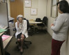 Patient relations representative Elena Griffing, left, talks on the phone while assisting imaging services manager Dianna Bennett, right, at Sutter Health Alta Bates Summit Medical Center in Berkeley, Calif., Monday, April 11, 2016. Griffing, 90, has started her 70th year working for the same San Francisco Bay Area hospital. (AP Photo/Jeff Chiu)