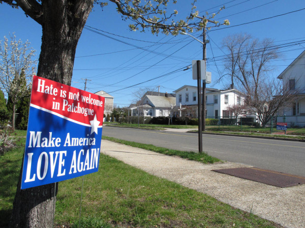 A sign sits near the site where Marcelo Lucero was killed in Patchogue, N.Y., on Wednesday, April, 13, 2016. The Rev. Alan Ramirez, an adviser to the family of Lucero, has called for Donald Trump to cancel a planned appearance at a Suffolk County Republican Committee fundraiser on Thursday, April 14, in Patchogue, because it is being held at a nightclub just blocks from where a gang of teenagers killed Lucero in November 2008. (AP Photo/Frank Eltman)