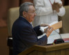 Cuba's President Raul Castro carries away a copy of his speech after addressing the 7th Cuban Communist Party Congress in Havana, Cuba, Saturday, April 16, 2016. Castro delivered a grim report on the state of the country, saying that the communist bureaucracy had failed to implement most of the hundreds of changes the ruling party launched five years ago to stimulate the stagnant centrally controlled economy. The party holds its four-day long Congress every five years. (Ismael Francisco/Cubadebate via AP)