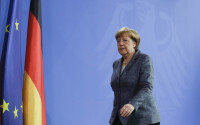 German Chancellor Angela Merkel leaves after a statement at the chancellery in Berlin, Friday, April 15, 2016. Chancellor Angela Merkel says the German government has granted a Turkish request to allow the possible prosecution of  German TV comedian Jan Boehmermann, who wrote a crude poem about Turkey's president. (AP Photo/Markus Schreiber)