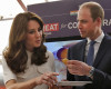 Britain's Prince William eats a "dosa",  or a rice pancake as his wife Kate, the Duchess of Cambridge, watches during an event on young entrepreneurs in Mumbai, India, Monday, April 11, 2016. (Danish Siddiqui/Pool Photo via AP)