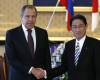 Russia's Foreign Minister Sergey Lavrov, left, and his Japanese counterpart Fumio Kishida shake hands for their meeting at the foreign ministry's Iikura guest house in Tokyo, Japan, Friday, April 15, 2016. (Toru Hanai/Pool Photo via AP)