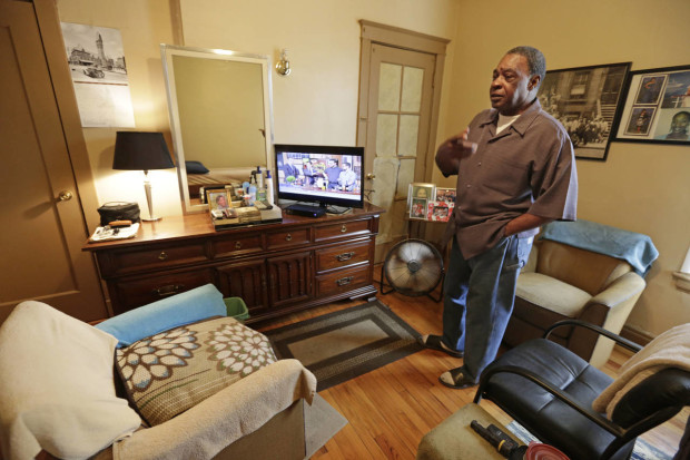 In this March 8, 2016 photo, George Wilson, a resident of a sober home in Chicago, stands in his apartment. Wilson, 76, is the oldest resident at the facility. (AP Photo/M. Spencer Green)