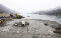 A city worker walks along a site that will soon host a life-sized whale sculpture and bridge park project along the Gastineau Channel, Wednesday, April 13, 2016, in Juneau, Alaska. The city is being sued by a industry representative for 12 cruise lines which alleges that the city is misspending funds from a per-passenger tax on the whale project and others which do not directly benefit cruise passengers.  (AP Photo/Rashah McChesney)