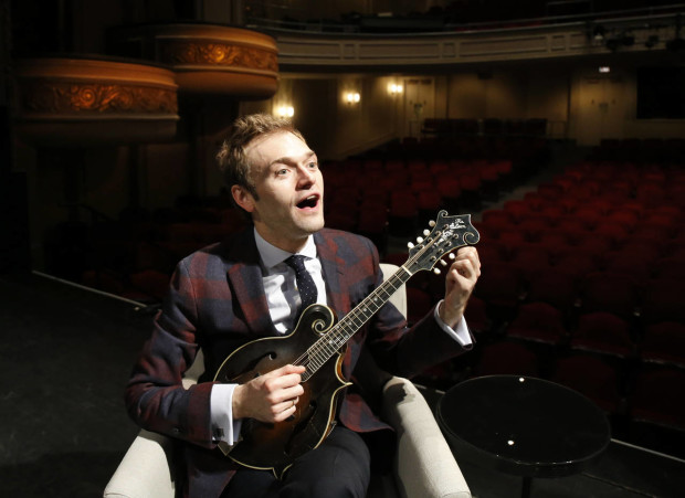 In this April 5, 2016 photo, Chris Thile plays his mandolin on stage at the Fitzgerald Theater in St. Paul, Minn. Thile will replace Garrison Keillor as host of "A Prairie Home Companion," the popular public radio variety show, after Keillor retires this summer. Thile starts hosting a 13-episode run of the show in October. (AP Photo/Ann Heisenfelt)