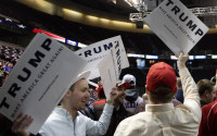 Supporters of Republican presidential candidate Donald Trump hold signs before a rally at the Times Union Center on Monday, April 11, 2016, in Albany, N.Y. (AP Photo/Mike Groll)