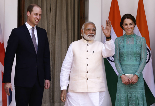 Britain's Prince William, left, and his wife Kate, the Duchess of Cambridge, right, are greeted by Indian Prime Minister Narendra Modi as they arrive for a lunch with him, in New Delhi, India, Tuesday, April 12, 2016. The Duke and Duchess of Cambridge are on a weeklong visit to India, their first royal tour in two years.  (AP Photo/Saurabh Das)