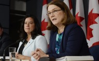 Canada's Health Minister Jane Philpott, right, speaks as Justice Minister Jody Wilson-Raybould listens at a news conference in Ottawa on Thursday, April 14, 2016. Canada has introduced a new assisted suicide law that will only apply to Canadians and residents, meaning Americans won't be able to travel to Canada to die. Visitors will be excluded under the proposed law announced Thursday, precluding the prospect of suicide tourism. Canadian government officials said to take advantage of the law the person would have to be eligible for health services in Canada.  (Adrian Wyld /The Canadian Press via AP) MANDATORY CREDIT