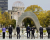 U.S. Secretary of State John Kerry, center left, puts his arm around Japan's Foreign Minister Fumio Kishida, center right, after they and fellow G7 foreign ministers laid wreaths at the cenotaph at Hiroshima Peace Memorial Park in Hiroshima, western Japan Monday, April 11, 2016. Also pictured are, from left to right, E.U. High Representative for Foreign Affairs Federica Mogherini, Canada's Foreign Minister Stephane Dion, Britain's Foreign Minister Philip Hammond, Germany's Foreign Minister Frank-Walter Steinmeier, Italy's Foreign Minister Paolo Gentiloni and France's Foreign Minister Jean-Marc Ayrault.  (Jonathan Ernst/Pool Photo via AP)