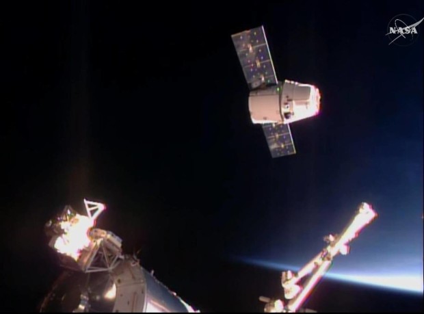 In this frame taken from video from NASA TV, the SpaceX Dragon cargo ship approaches the International Space Station, Sunday April 10, 2016. A SpaceX Dragon cargo ship arrived at the International Space Station on Sunday, two days after launching from Cape Canaveral, Florida. Station astronauts used a big robot arm to capture the Dragon, orbiting 260 miles above Earth. (NASA TV via AP)