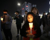 A mother and her daughter hold a candle to pay their respects to the victims of the sunken ferry Sewol during a ceremony on the eve of the second anniversary of the ferry sinking in Ansan, South Korea, Friday, April 15, 2016. Two year ago, as South Korea writhed in grief and fury after more than 300 people, most of them school kids, drowned in a ferry sinking, it seemed things would never be the same.(AP Photo/Ahn Young-joon)