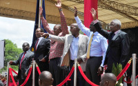 From left to right, Joshua Arap Sang, Henry Kosgei, President Uhuru Kenyatta, Major Gen. Hussein Ali, Kenyan Vice president William Ruto, and Ambassador Francis Muthaura, gesture,  as they attend a thanks giving rally, in Nakuru, Kenya,  Saturday, April 16, 2016. Kenyan President Uhuru Kenyatta and five others who had been charged with crimes against humanity at the International Criminal Court held a rally attended by thousands to celebrate the withdrawal of the charges against them. The rally has been opposed by opposition leader Raila Odinga and some members of civic organizations who say it does not respect the suffering of the victims of violence following a disputed presidential election late 2007. (AP Photo/Kevin Midigo)