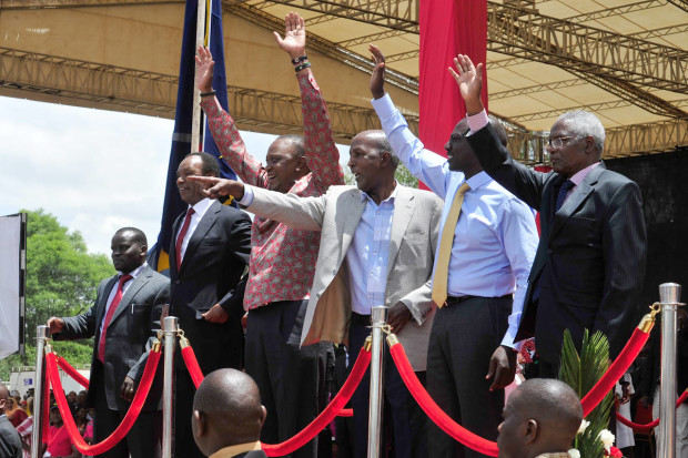 From left to right, Joshua Arap Sang, Henry Kosgei, President Uhuru Kenyatta, Major Gen. Hussein Ali, Kenyan Vice president William Ruto, and Ambassador Francis Muthaura, gesture,  as they attend a thanks giving rally, in Nakuru, Kenya,  Saturday, April 16, 2016. Kenyan President Uhuru Kenyatta and five others who had been charged with crimes against humanity at the International Criminal Court held a rally attended by thousands to celebrate the withdrawal of the charges against them. The rally has been opposed by opposition leader Raila Odinga and some members of civic organizations who say it does not respect the suffering of the victims of violence following a disputed presidential election late 2007. (AP Photo/Kevin Midigo)