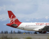 A Virgin America plane taxis before takeoff, Monday, April 4, 2016, at Seattle-Tacoma International Airport in Seattle. Alaska Airlines' parent company announced Monday that it will pay $2.6 billion to buy the Richard Branson-inspired, California-based Virgin America. (AP Photo/Ted S. Warren)