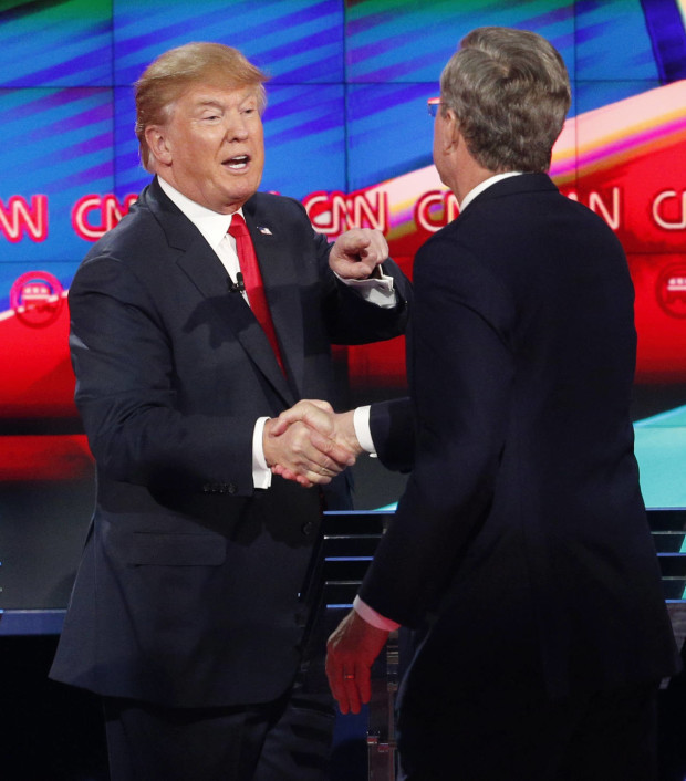 FILE - In this Dec. 15, 2015 file photo, Republican presidential candidate Donald Trump shakes hands with then-follow candidate Jeb Bush following the CNN Republican presidential debate in Las Vegas.  But rarely have so many partnerships of political necessity appeared to be as reluctant, awkward, even downright tortured as in the 2016 GOP race. (AP Photo/John Locher, File)