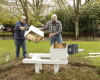 Olympia Beekeepers Association members Duane McBride, left, and Mark Emrich place bee hive boxes on the front lawn of the governor's mansion in Olympia, Wash., Thursday, April 14, 2016. About 30,000 European honeybees will be placed in the hives next week as part of an effort to raise awareness about the decline of bee populations, as well as to boost pollination of plants on the Capitol campus. (AP Photo/Rachel La Corte)