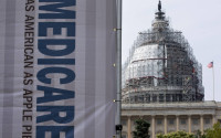 FILE - In this July 30, 2015 file photo, a sign supporting Medicare is seen on Capitol Hill in Washington. A Medicare proposal to test new ways of paying for chemotherapy and other drugs given in a doctor's office has sparked a furious battle, and cancer doctors are demanding that the Obama administration scrap the experiment. (AP Photo/Jacquelyn Martin, File)