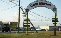 In this photo taken Feb. 2, 2016, the entrance to Camp America is seen at U.S. Guantanamo Naval Base, Cuba. Authorities say the U.S. has released nine prisoners from Guantanamo Bay and sent them to Saudi Arabia for resettlement. All nine are Yemeni but have family ties to Saudi Arabia. None of the men had been charged and all but one had been cleared for release from the U.S. base in Cuba since at least 2010. One was approved for release by a review board last year.  (AP Photo/Ben Fox)