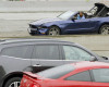 Two people in a convertible Mustang speed down the busy Harbor Freeway (Interstate 110) in downtown Los Angeles as they are pursued in a chase on rainy Southern California streets and highways, Thursday, April 7, 2016. Authorities arrested the two burglary suspects after they stopped the car in a South Los Angeles neighborhood, exchanged high-fives with onlookers and took selfies before officers arrived several minutes later and handcuffed them. (AP Photo/Reed Saxon)