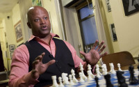 In this April 12, 2016 photo, chess grandmaster Maurice Ashley talks during an interview at Chess Forum in New York. The Brooklyn resident has been inducted to the World Chess Hall of Fame in St. Louis. (AP Photo/Mark Lennihan)