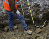 FILE--In this March 21, 2016 file photo, a lead main service line is exposed and measured as members of Eagle Excavation Inc., Goyette Mechanical Co., and Mechanical Contractors Johnson & Wood work together to dig a hole to expose, remove and replace a lead main service line in Flint, Mich. Michigan would have the toughest lead-testing rules in the nation and require the replacement of all underground lead service pipes in the state under a sweeping plan Gov. Rick Snyder and a team of water experts will unveil Friday, April 15, 2016 in the wake of Flint's water crisis. (Rachel Woolf/The Flint Journal-MLive.com via AP) LOCAL TELEVISION OUT; LOCAL INTERNET OUT; MANDATORY CREDIT